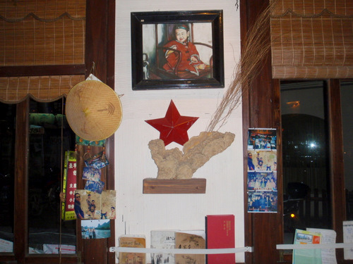 A liberal restaurant displays a picture of the Last Emperor and Mao.